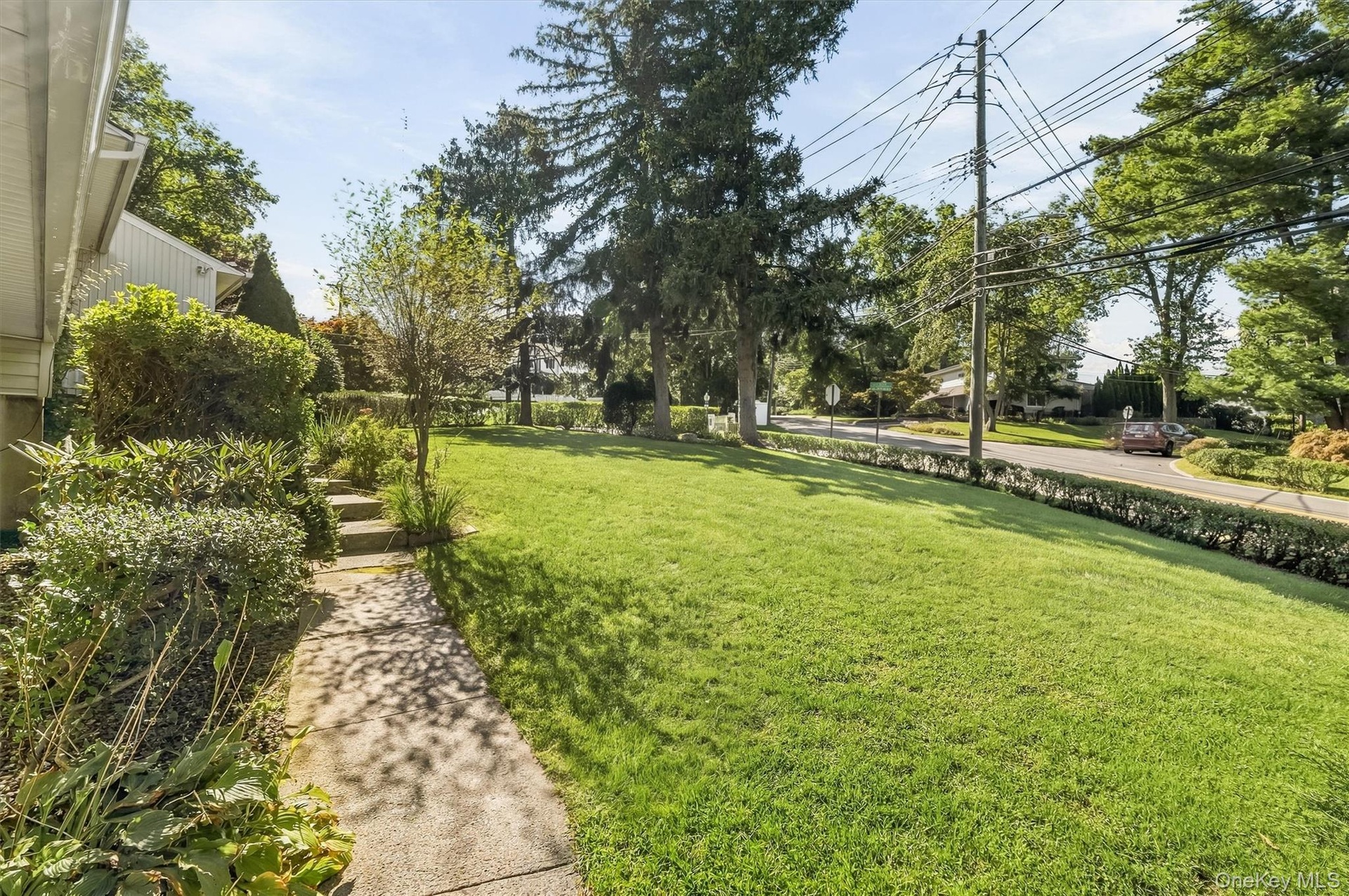 A gracious approach, framed by greenery