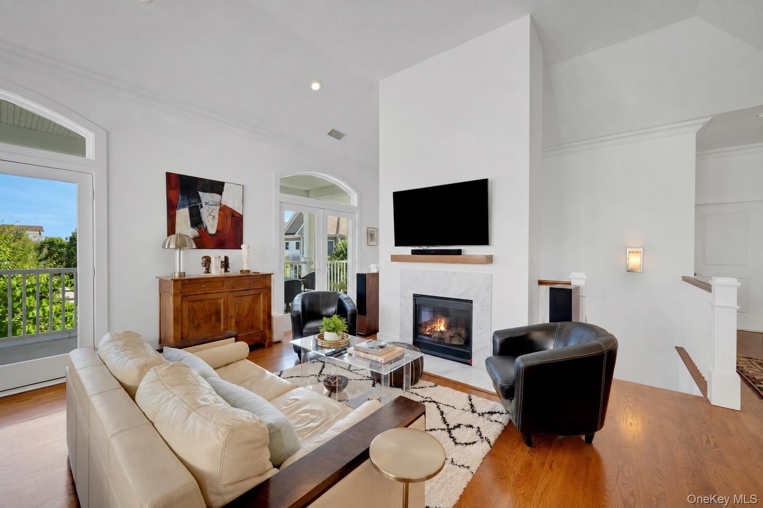 Large living area with double french doors leading out to 40 ft terrace with views of the LI Sound