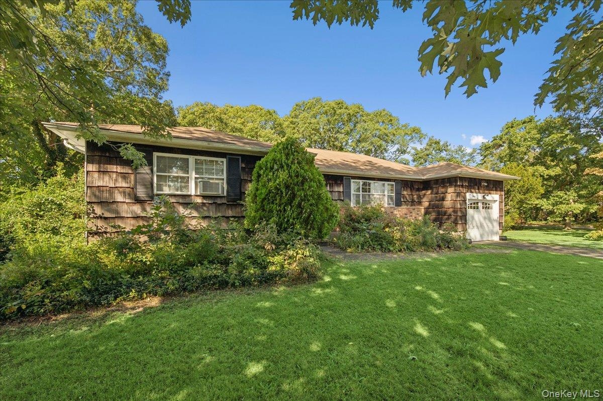 Cedar shake siding, attached garage with carriage-style door