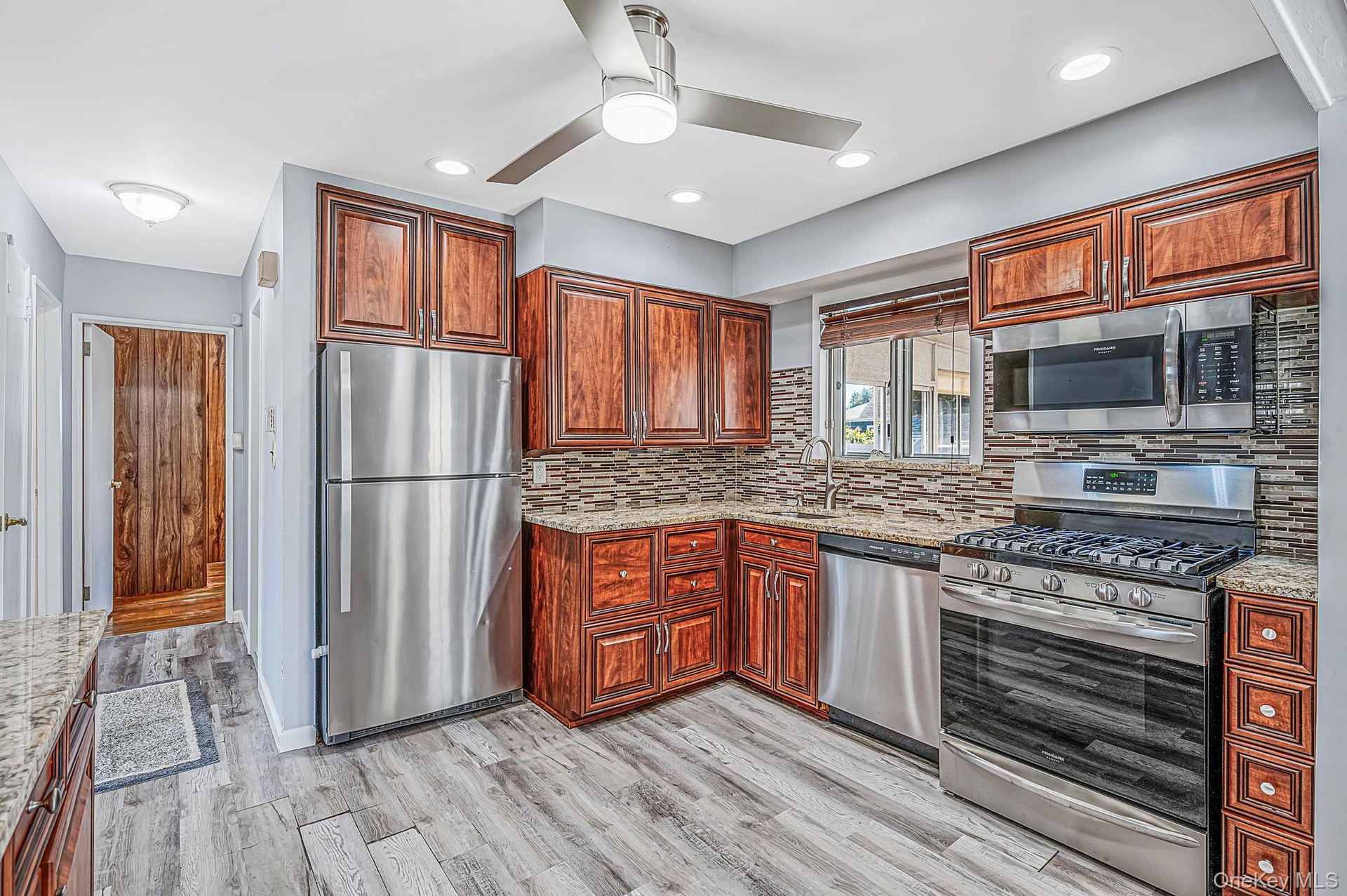 Updated EIK with SS Appliances, Gas Cooking, Large Dining Area, Sliders to Sunroom