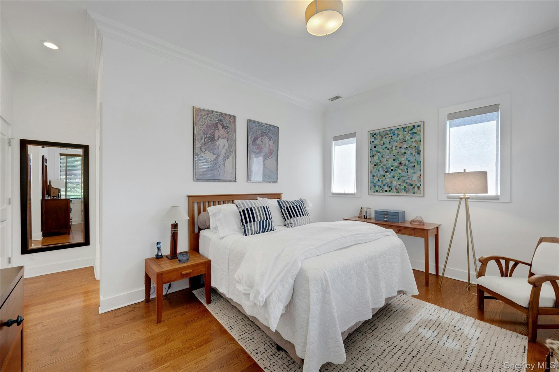 Spacious primary bedroom featuring a walk-in closet and 2nd custom closet. Hardwood floors throughout.