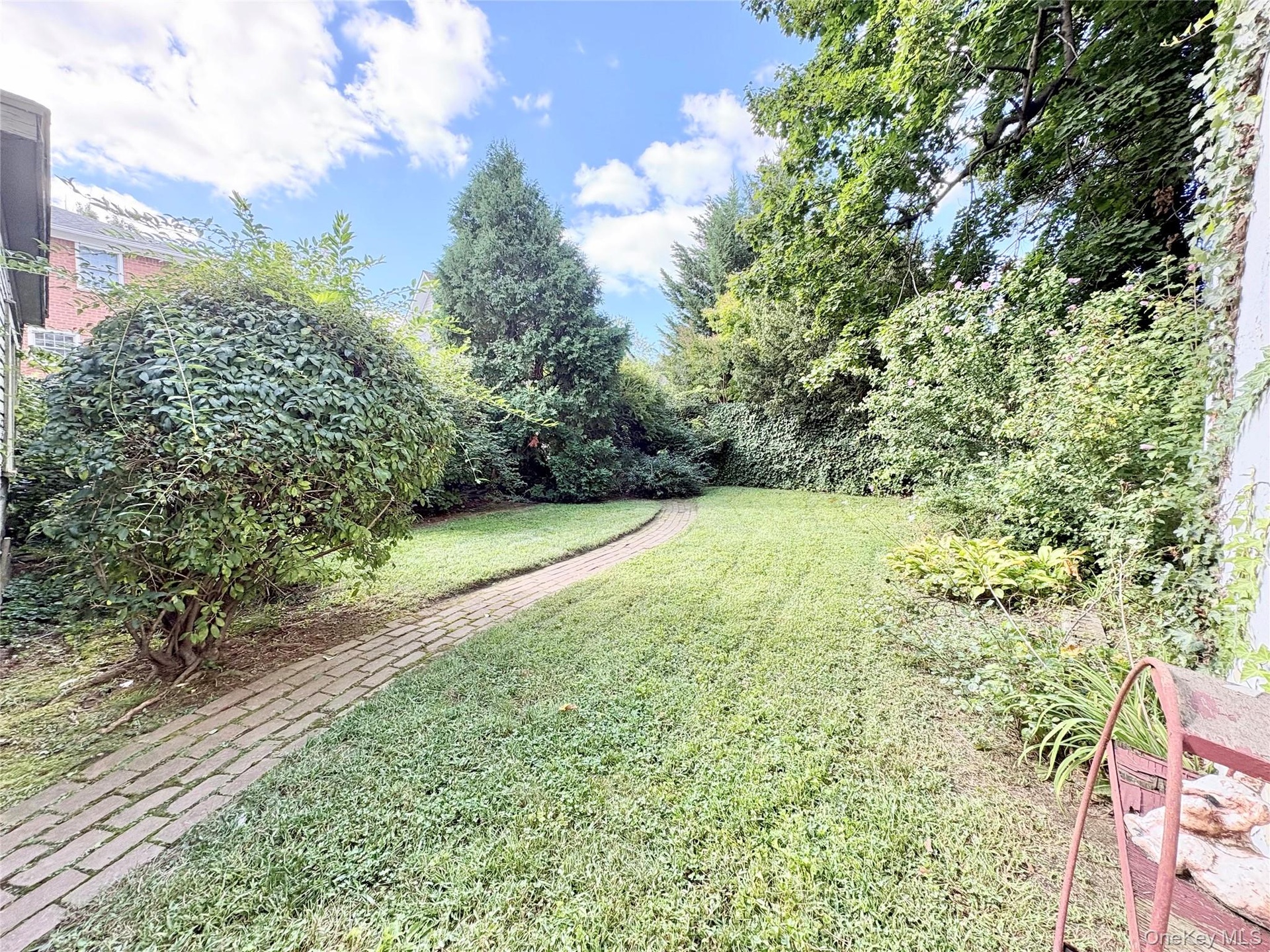 Back Yard, lawn, bushes and brick path