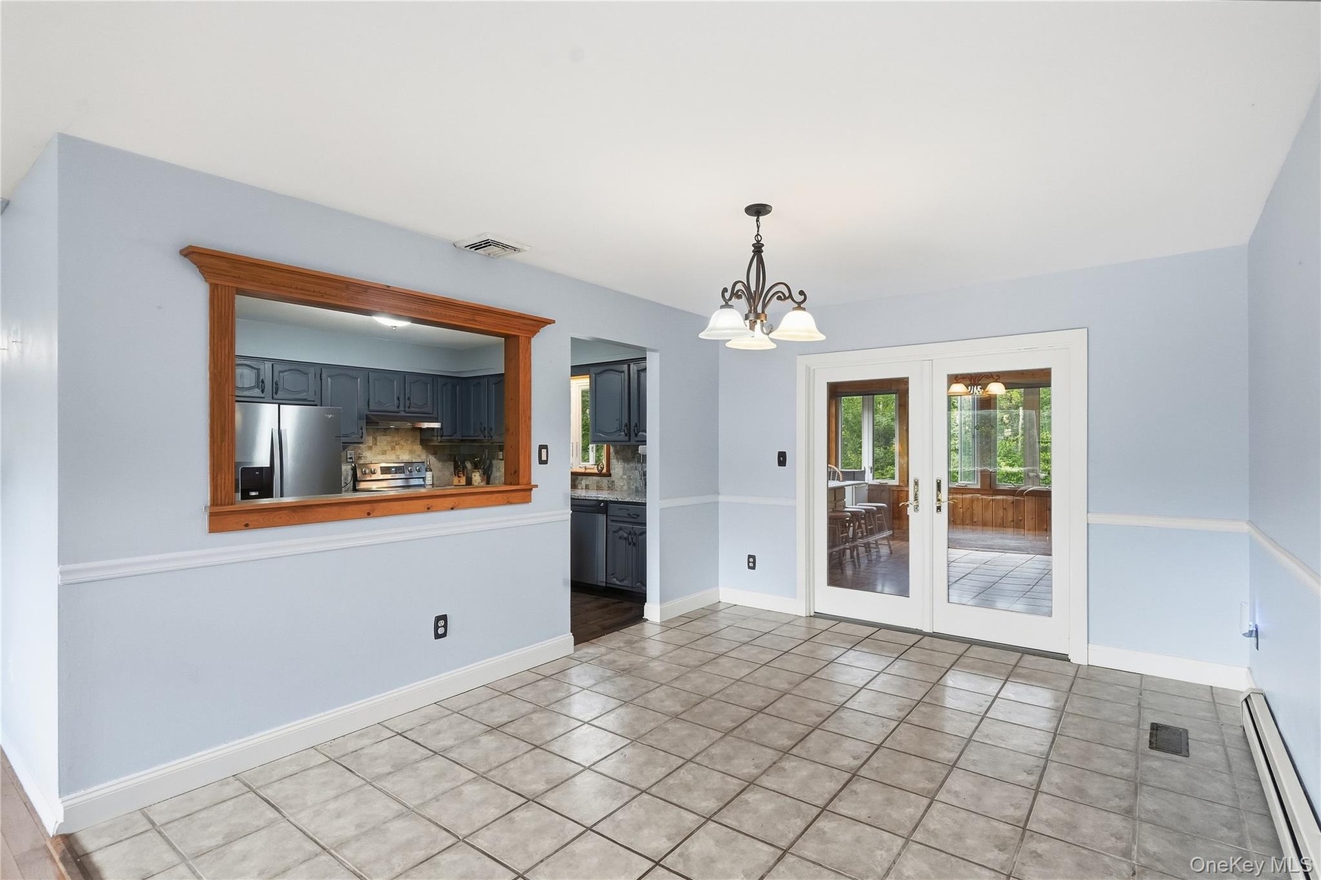 French doors lead to the three seasons room