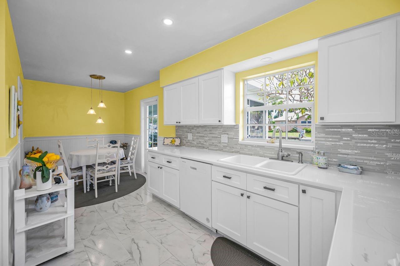 Kitchen with canned lighting and door to the screened lanai
