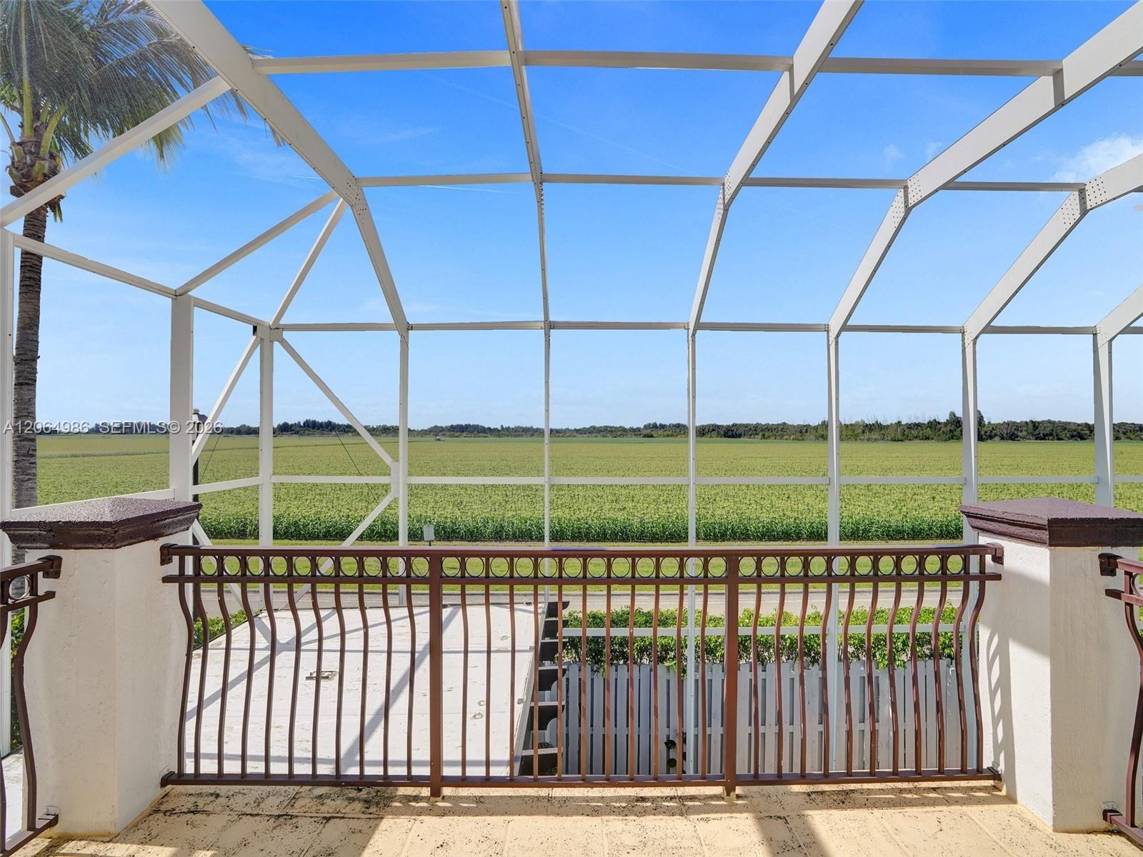 SCREENED BALCONY OVERVIEWING POOL AND OPEN FIELD TO ENJOY BEAUTIFUL ROMANTIC SUNSETS.