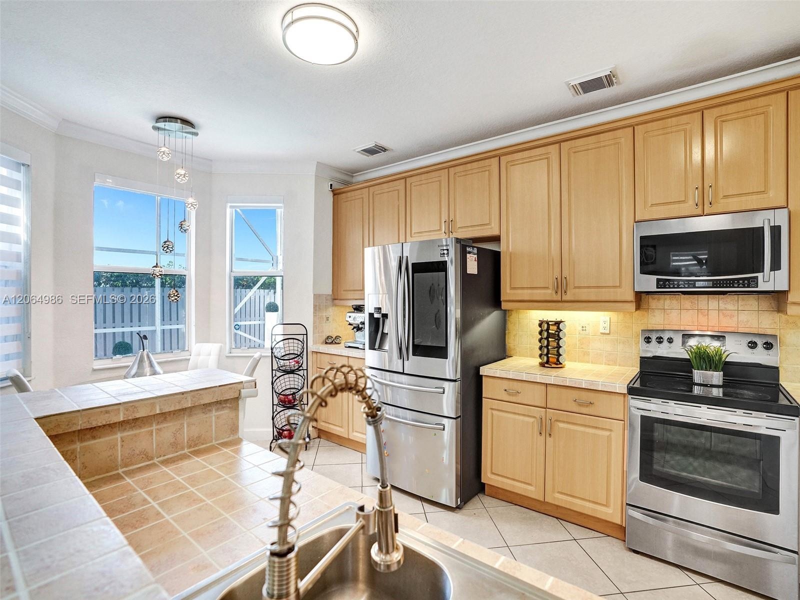 AMPLE KITCHEN WITH BREAKFAST NOOK OVERLOOKING POOL AREA