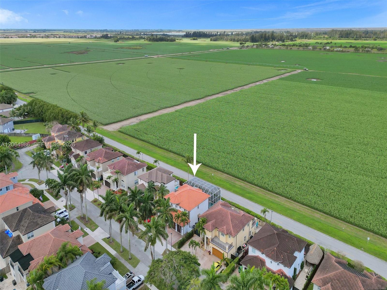 AERIAL VIEW OF COMMUNITY WITH IMPRESSIVE VIEW OF FIELD IN BACK OF PROPERTY.