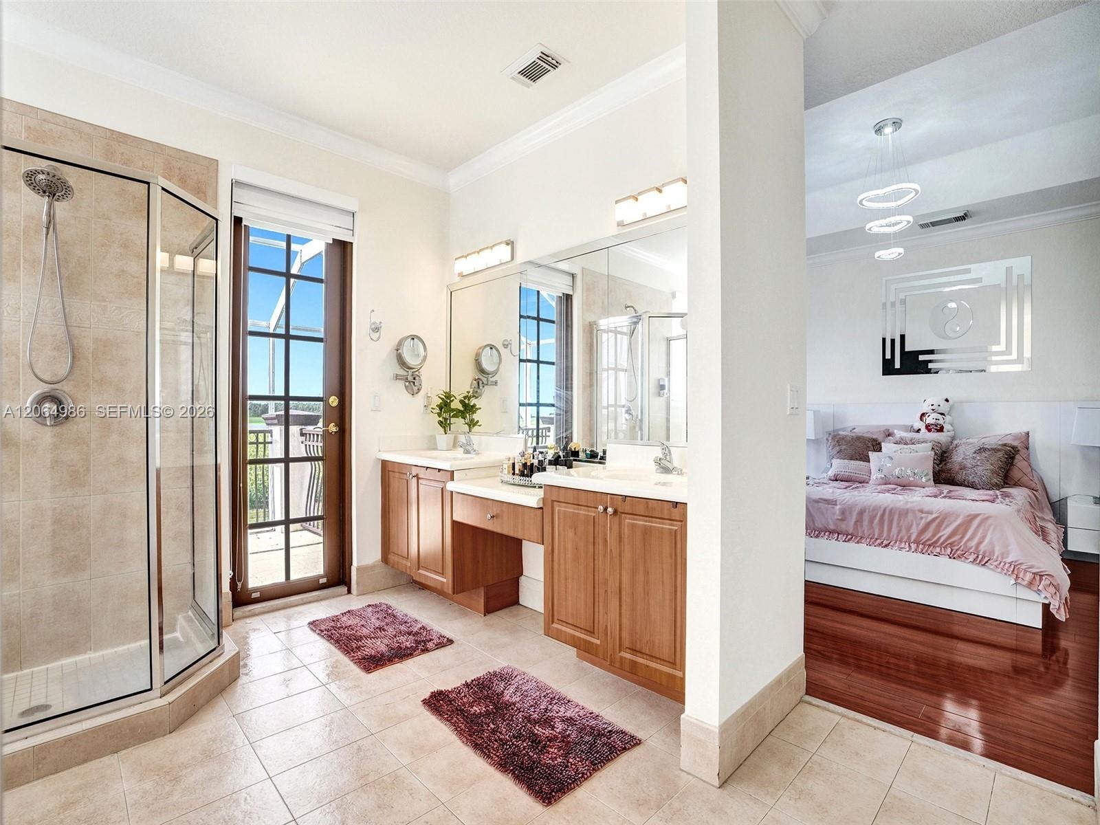 PARTIAL VIEW OF MASTER BATHROOM WITH FRENCH DOOR LEADING TO BALCONY WHERE YOU CAN ENJOY ROMANTIC SUNSETS BEHIND CORN FIELD.