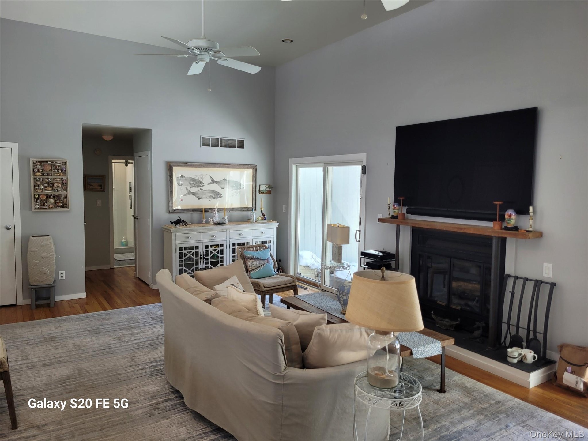 with sliders to backyard deck and pool area with gardens and entertaining Gazebo