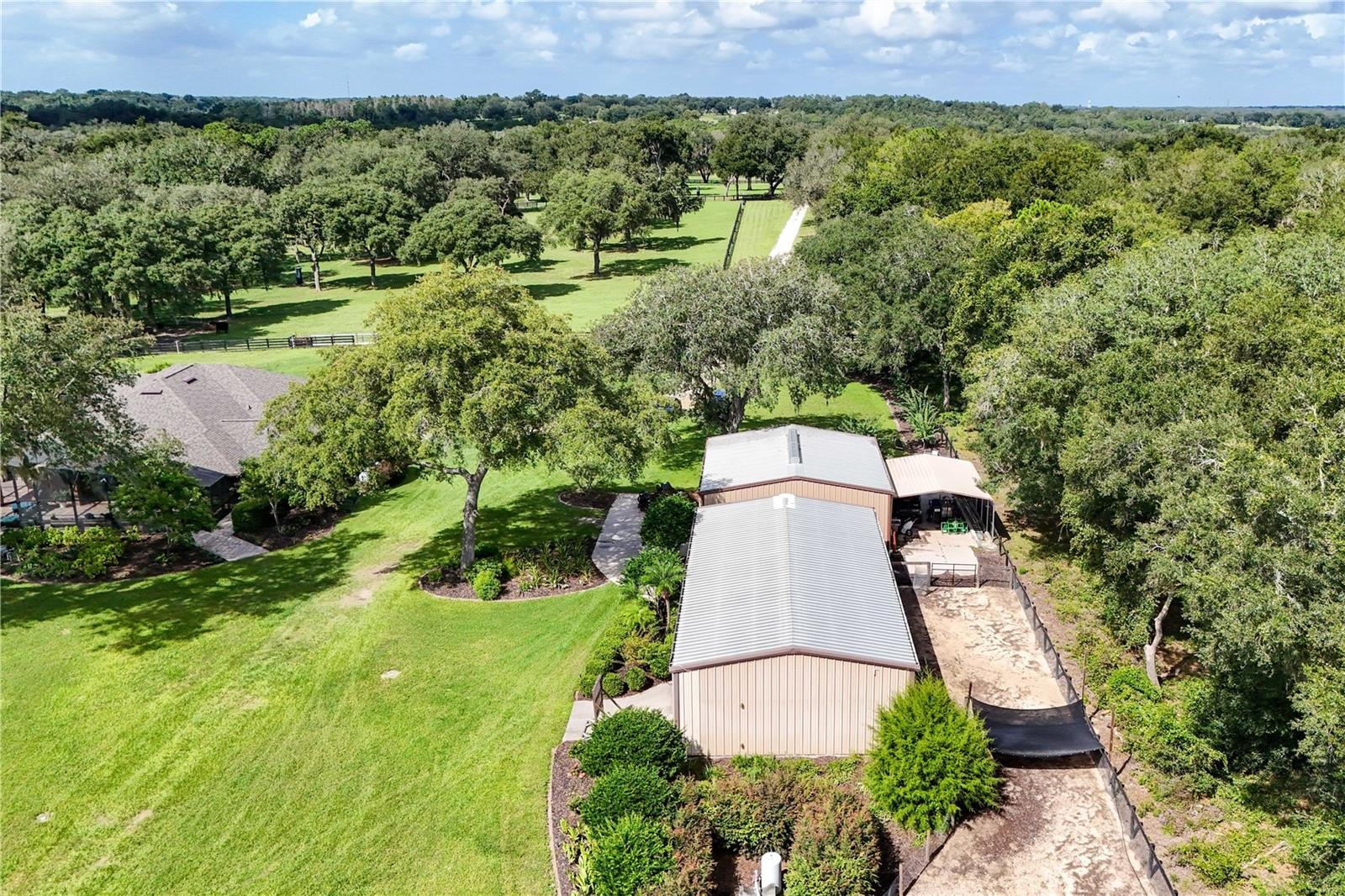 aerial of in law house/storage and equipment garage/shop along with rv/trailer parking and chicken run