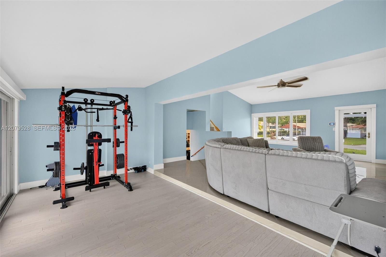 Living rm on main level. Primary bedroom to right. stairs up and down to the left. Volume beamed ceilings, impact windows, plantation shutters