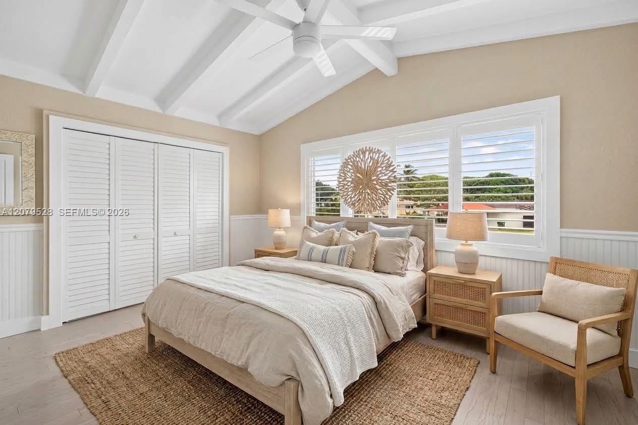 Large guest bedroom upstairs w/ views to front of house, beamed ceiling. Virtually Staged.