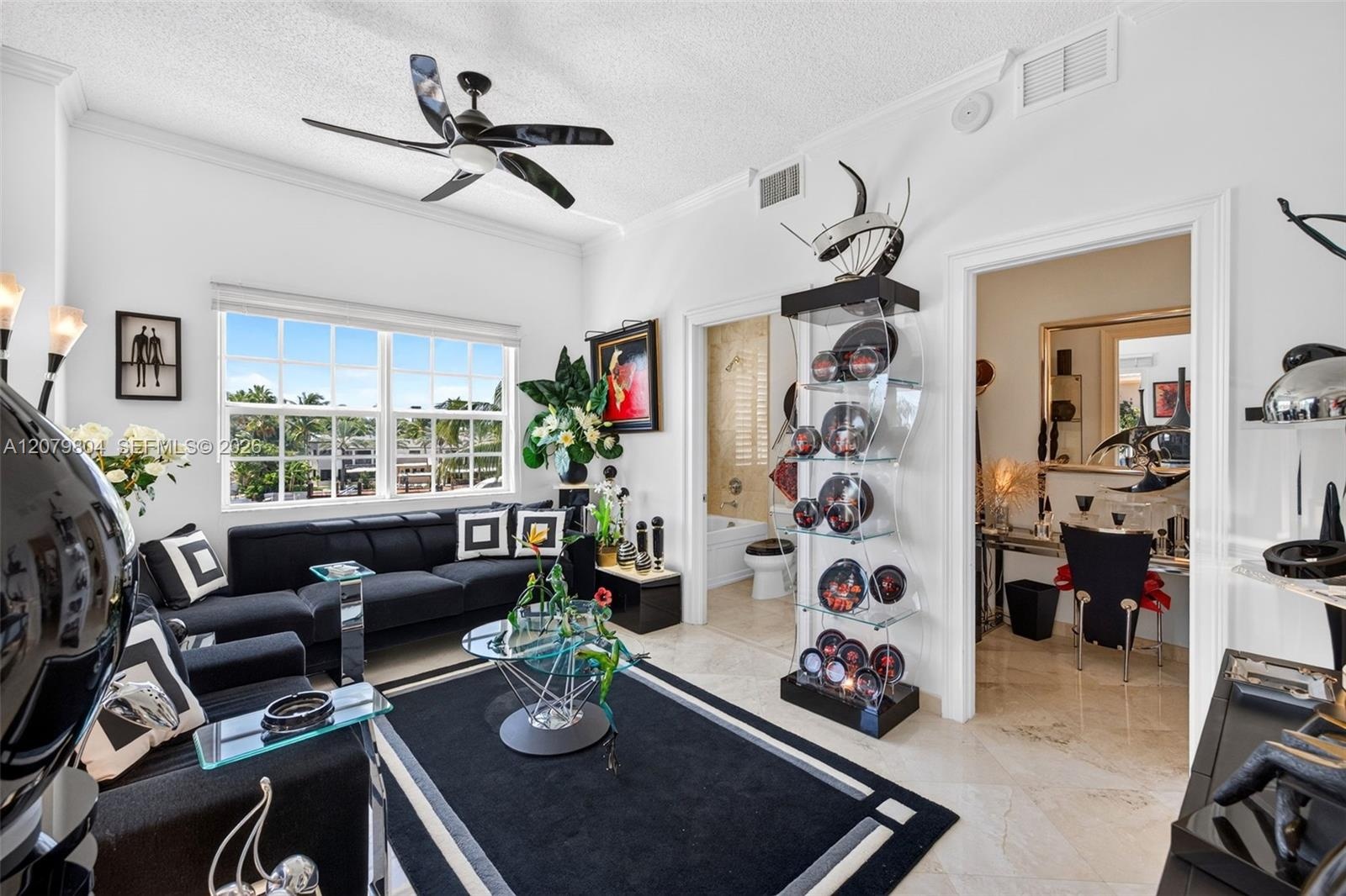 Guest Bedroom in unit 303. Bright / Modern w/ all Marble Flooring, views to Downtown, Impact Windows & Doors. En suite bathroom, and the space on the 
