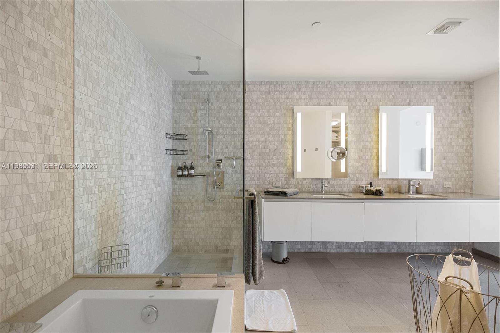 Neutral interior featuring solid-core doors, light-toned tile flooring, and integrated wall-mounted television hardware