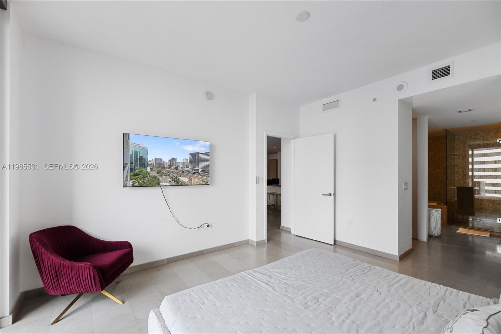 Custom walk-in closet featuring extensive built-in white shelving, integrated multi-level hanging rods, and a center built-in drawer unit with frosted