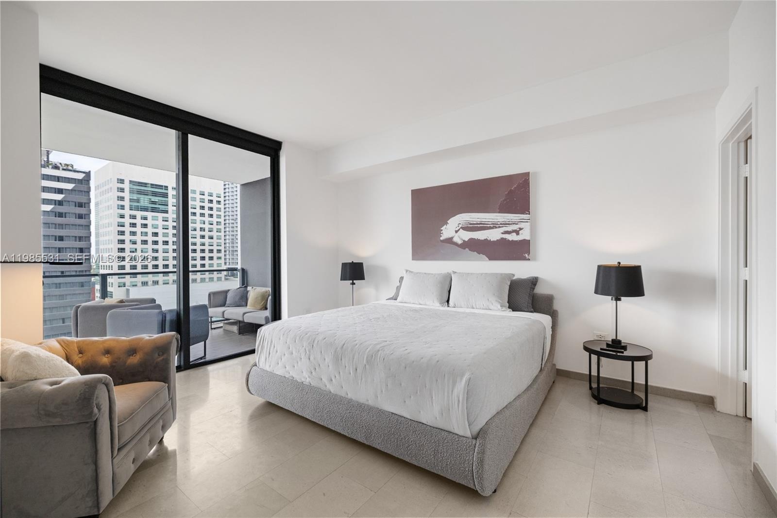 Private balcony featuring wood-finish tile flooring and a glass-paneled metal railing