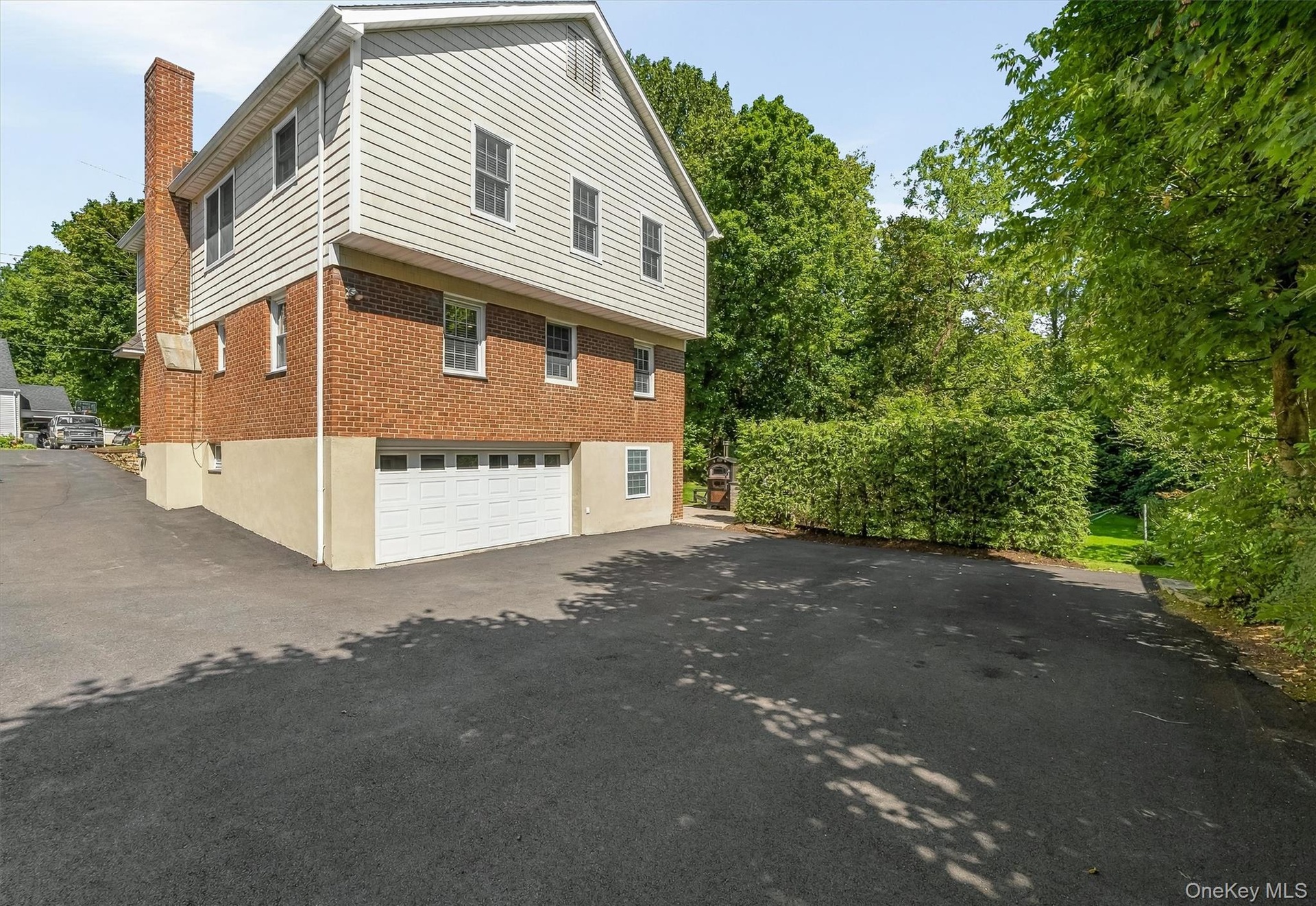 A spacious driveway with room for six cars, plus a garage.