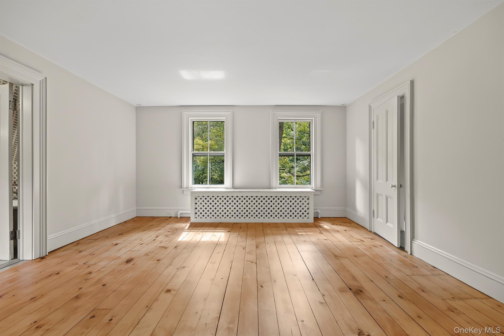 Primary Bedroom with Walk-in Closet and Gleaming Hardwood Floors
