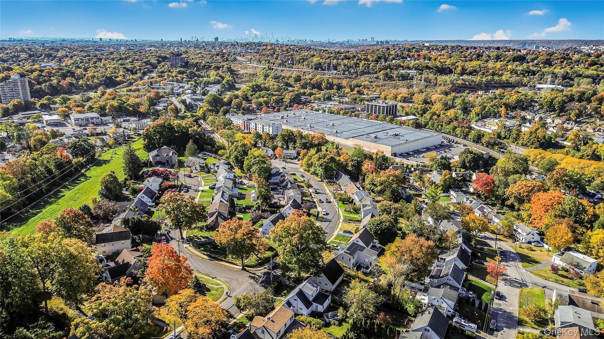 Aerial view of property's location with nearby suburban area