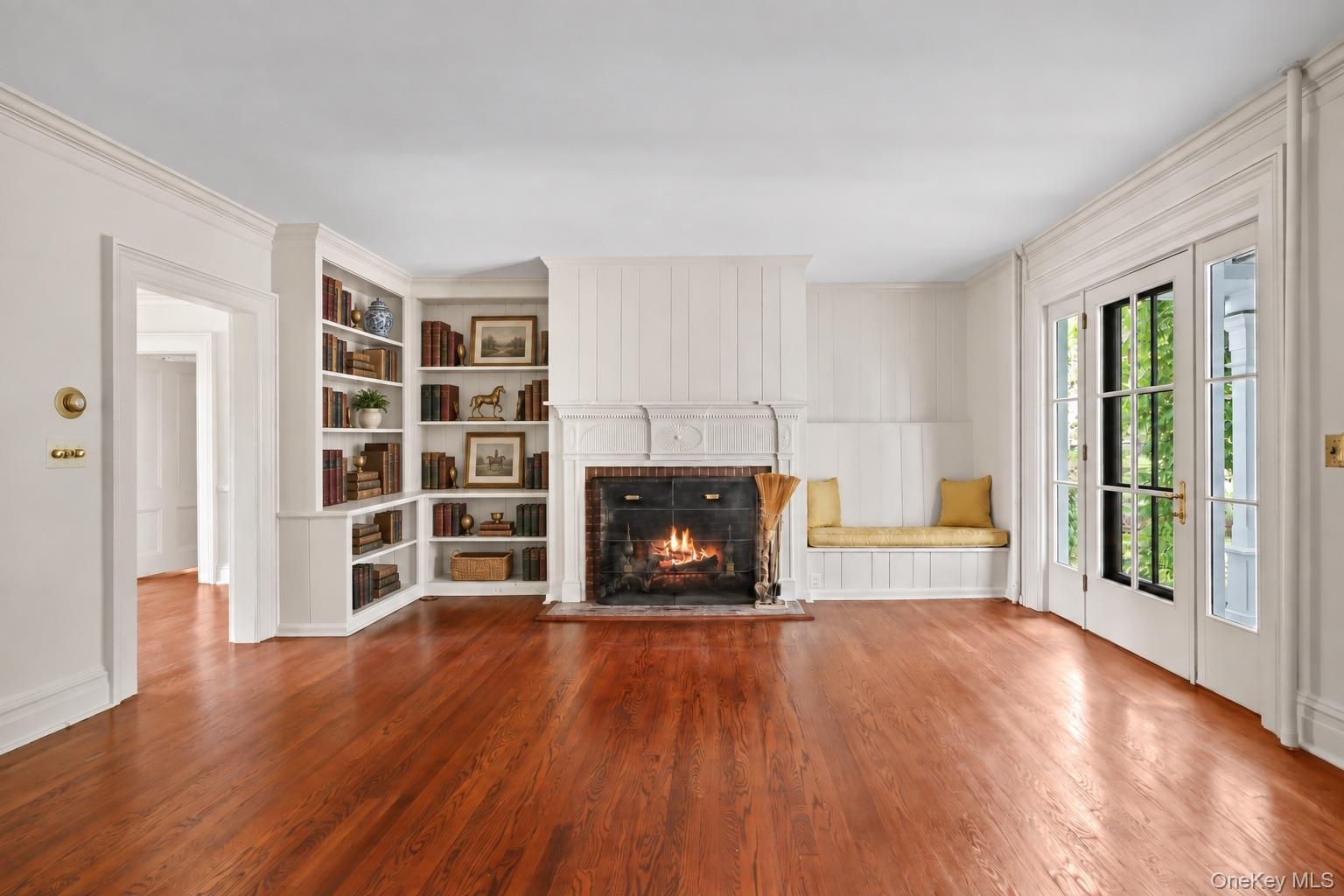 Expansive Living Room with Wood Burning Fireplace and Built-Ins