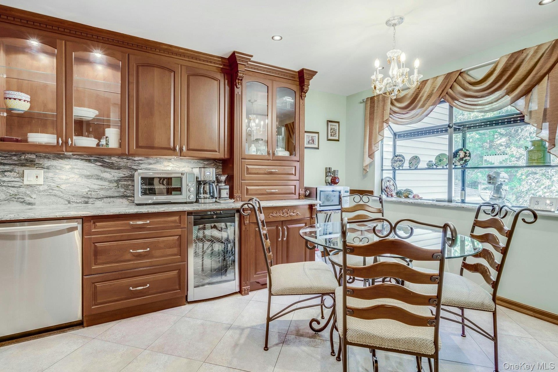 SS Bosch double oven, dishwasher and cooktop, vented hood, GE profile wine refrigerator and kitchenaide double door frig