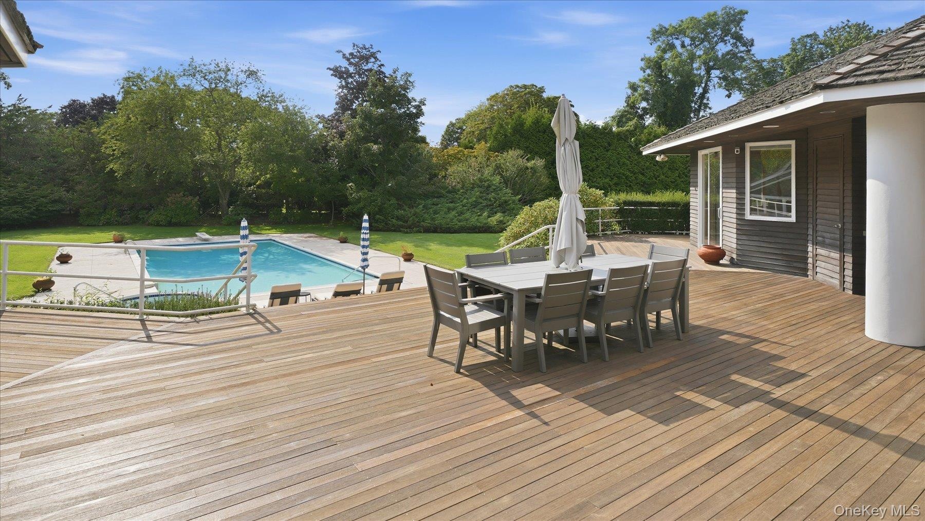 Al fresco deck dining with view to pool