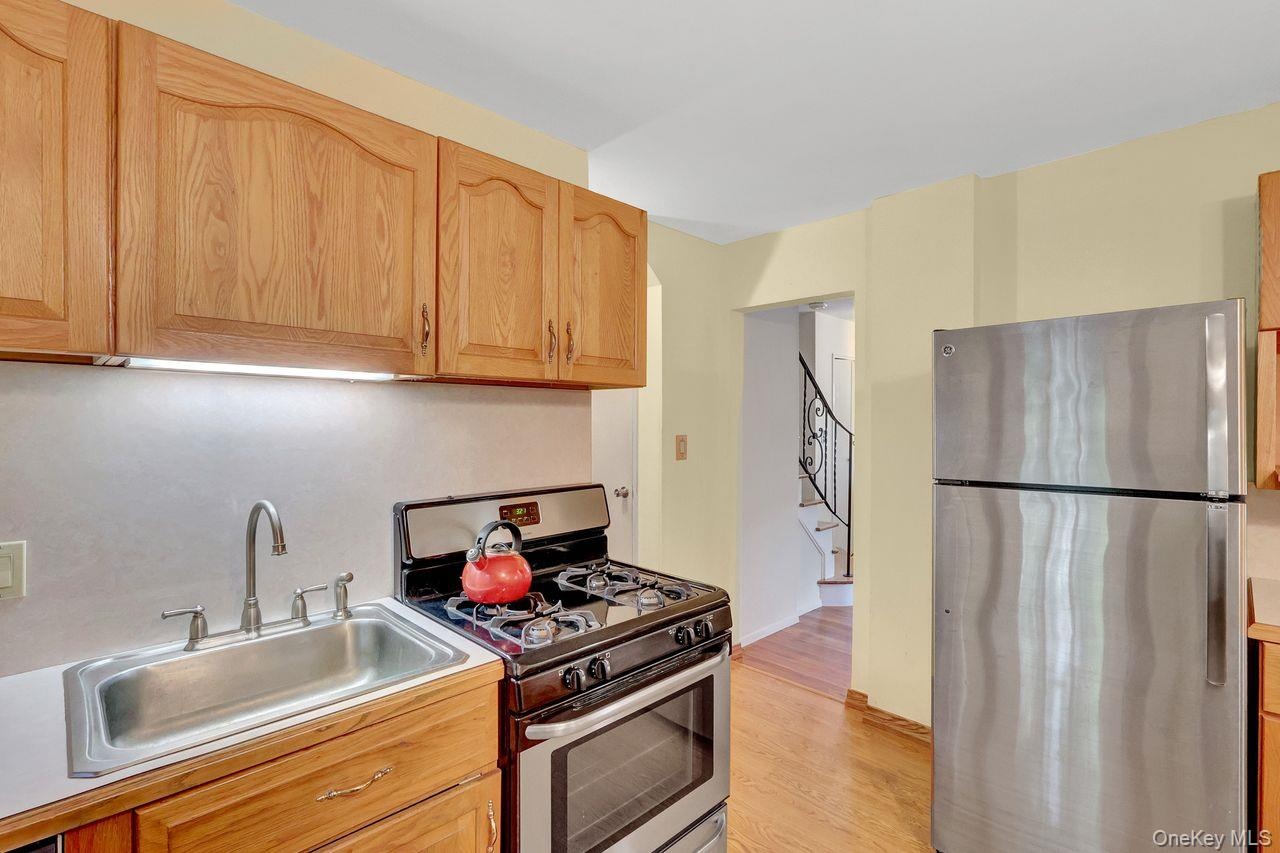 Additional cabinets and counter top next to the refrigerator