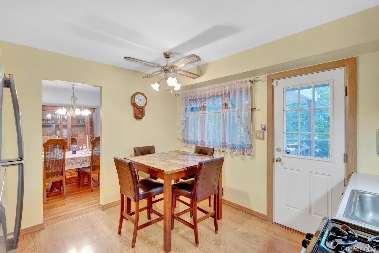 Wood-finish flooring throughout, with a ceiling fan light fixture