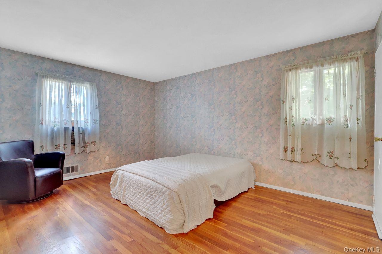 Primary Bedroom with Hardwood flooring