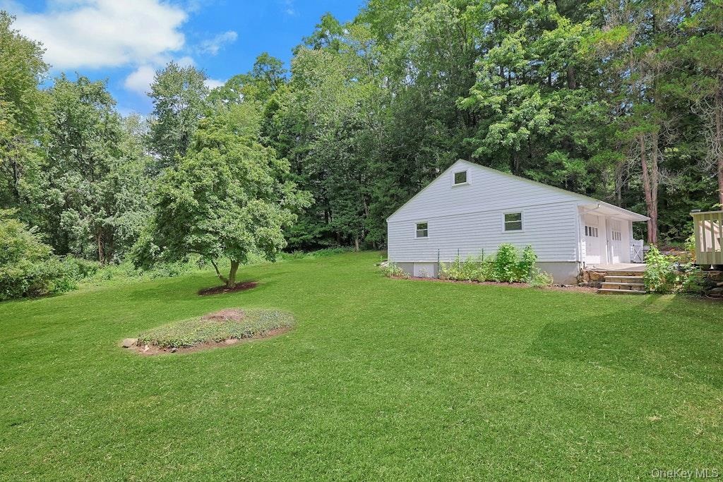 A beautiful view of the expansive, level yard, offering plenty of space for outdoor entertaining and recreation!