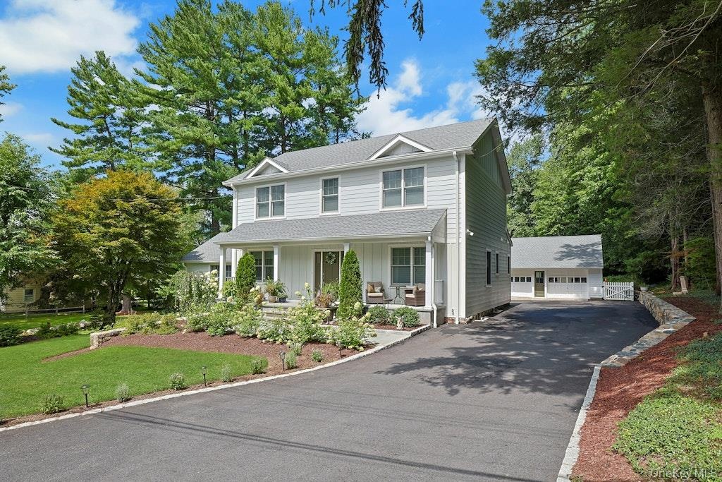 A beautiful view showcasing the home’s inviting front porch, charming exterior, and wonderful curb appeal.
