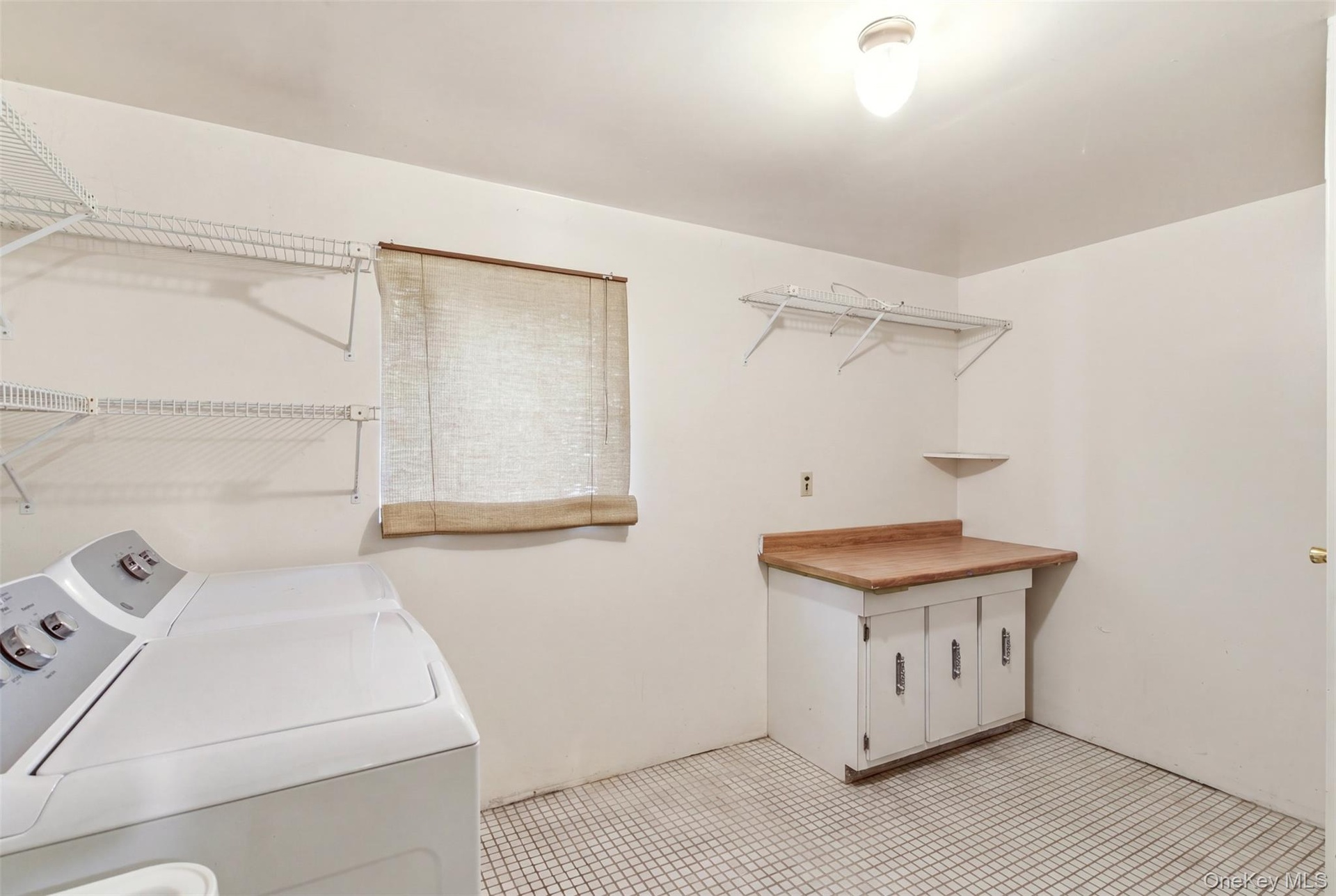 Spacious Laundry Room With New Washer and Dryer