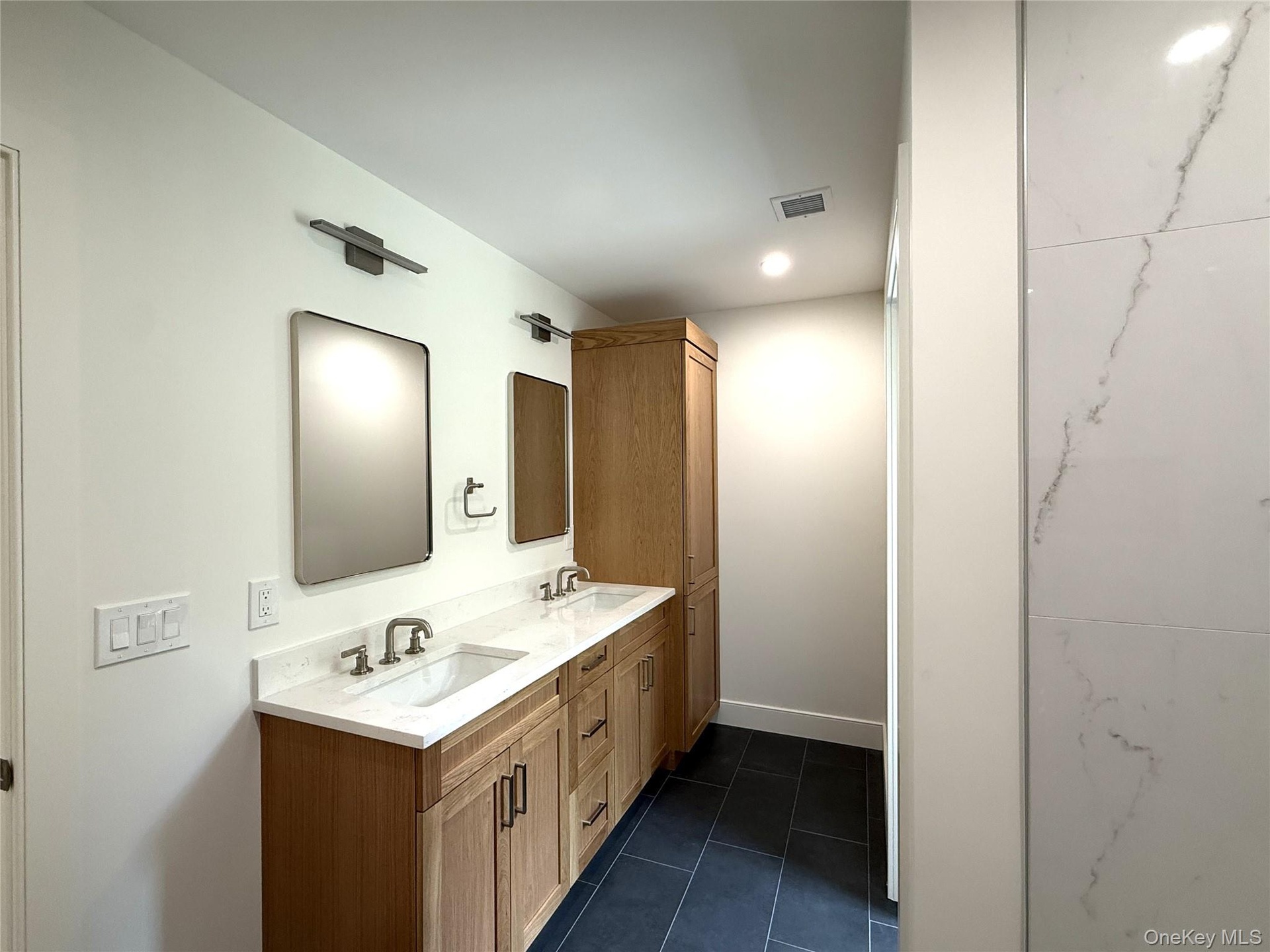 Double sink vanity and recessed lighting in Bathroom