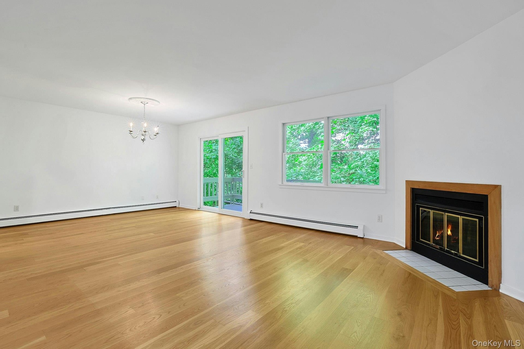 A wood-burning fireplace at the head of the living room is great for a crisp fall or winter evening. Open to the dining room - enjoy the crackling fir