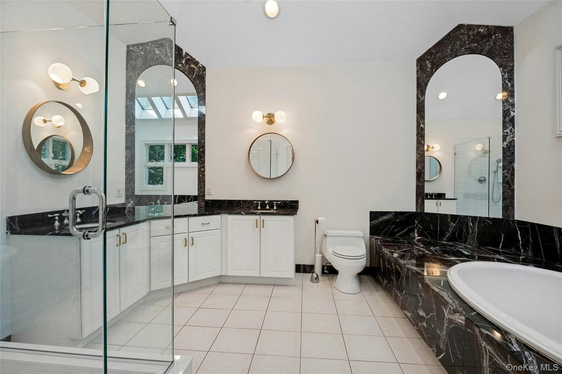 Large walk in shower, dual sinks, soaking tub and skylights complete this spacious bathroom