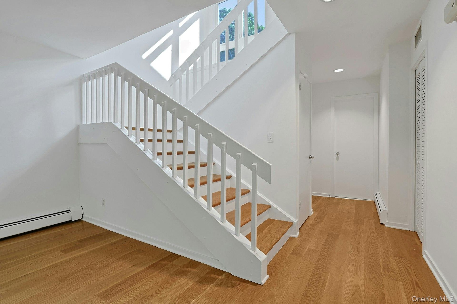 Inside, there is an updated hall bath just next to the entrance. A coat closet and deep, under-stair storage area make keeping this space neat a breez