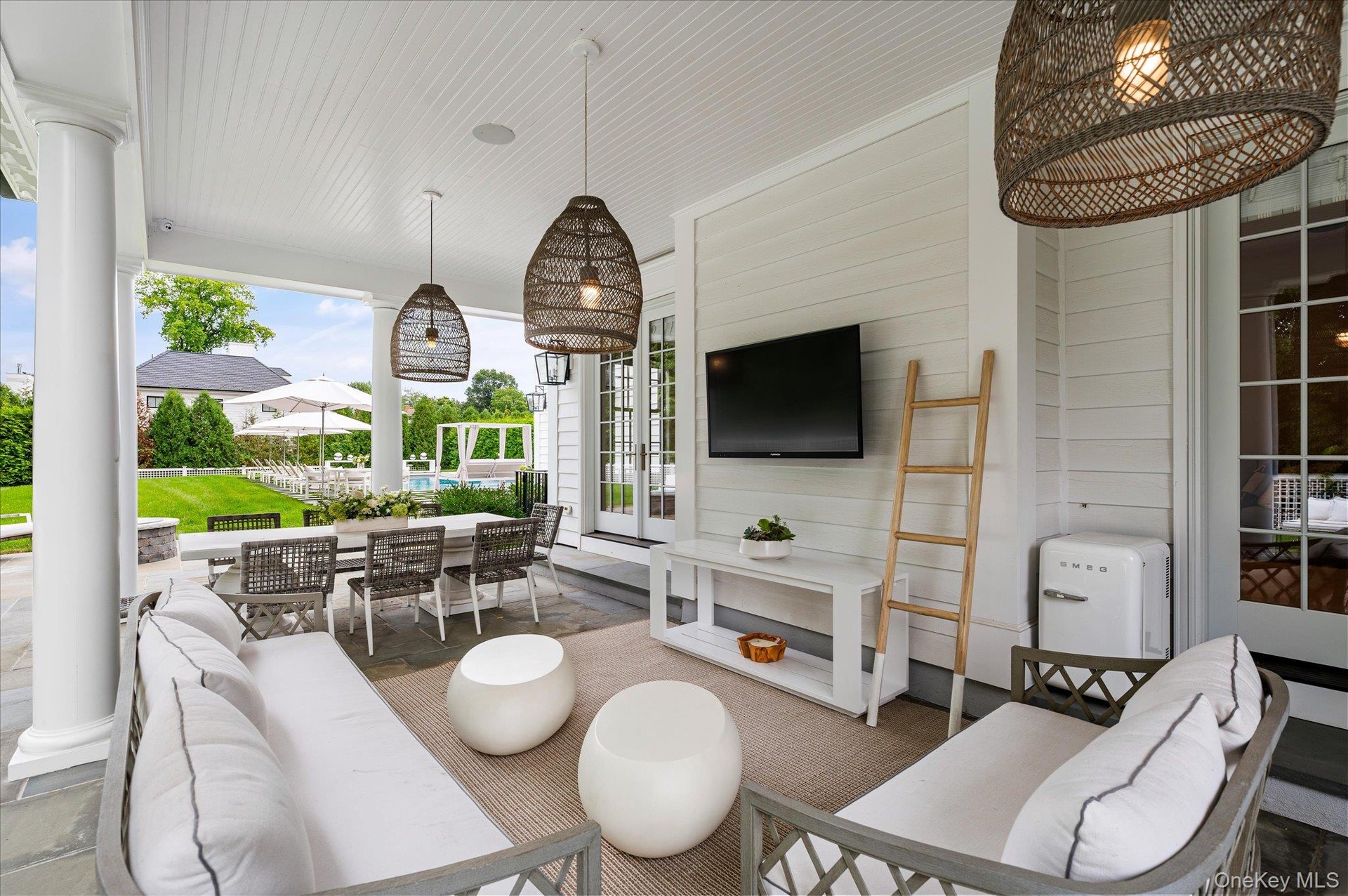 Covered veranda with sitting area and dining area.
