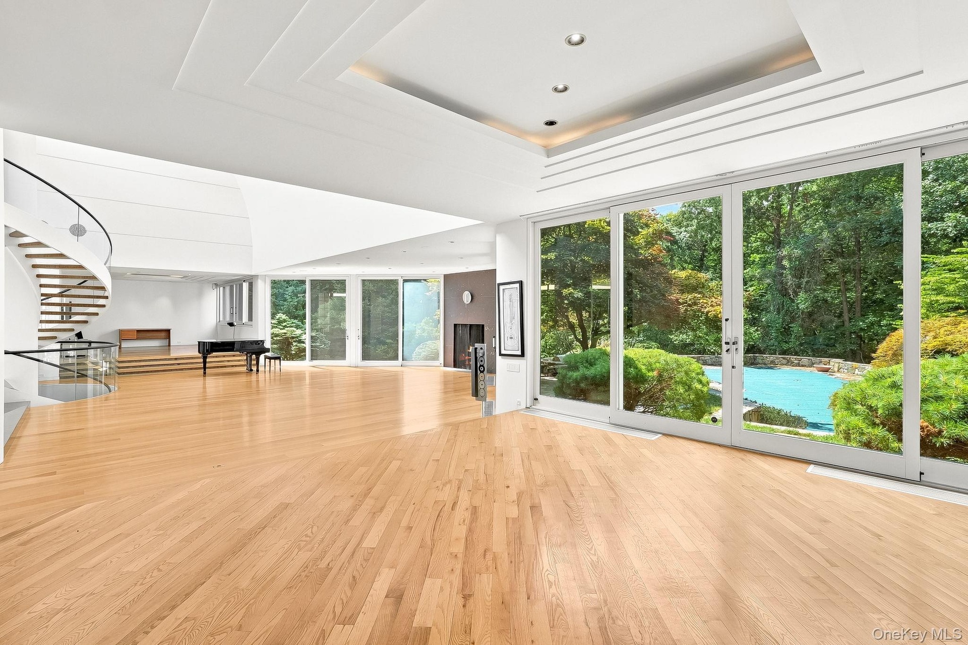 Open floor concept. Living room and dining room with view ceiling to floor sliding doors leading to backyard.
