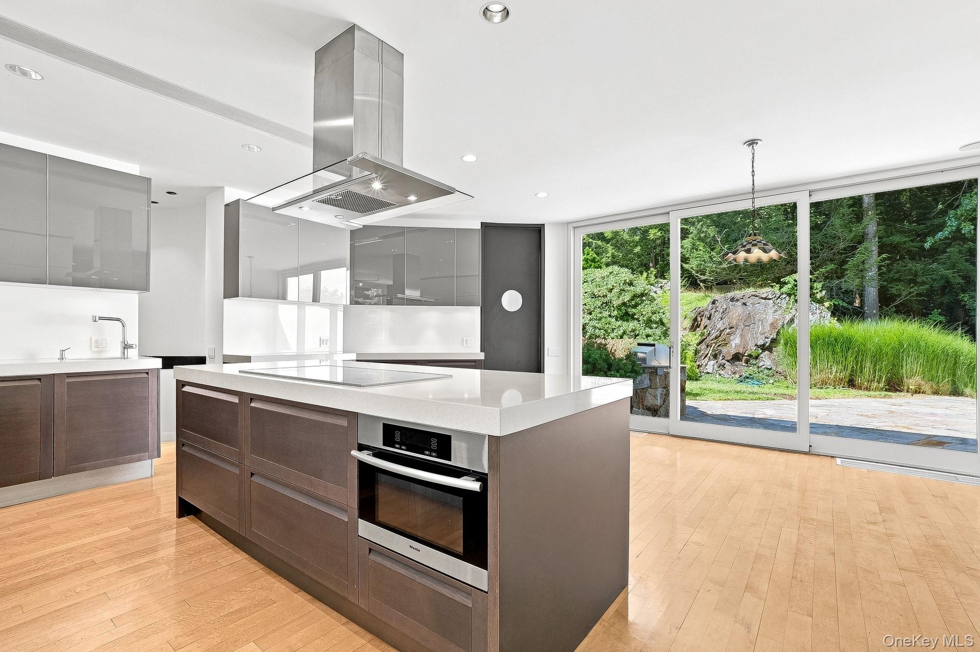 Kitchen island includes stove top and oven.
