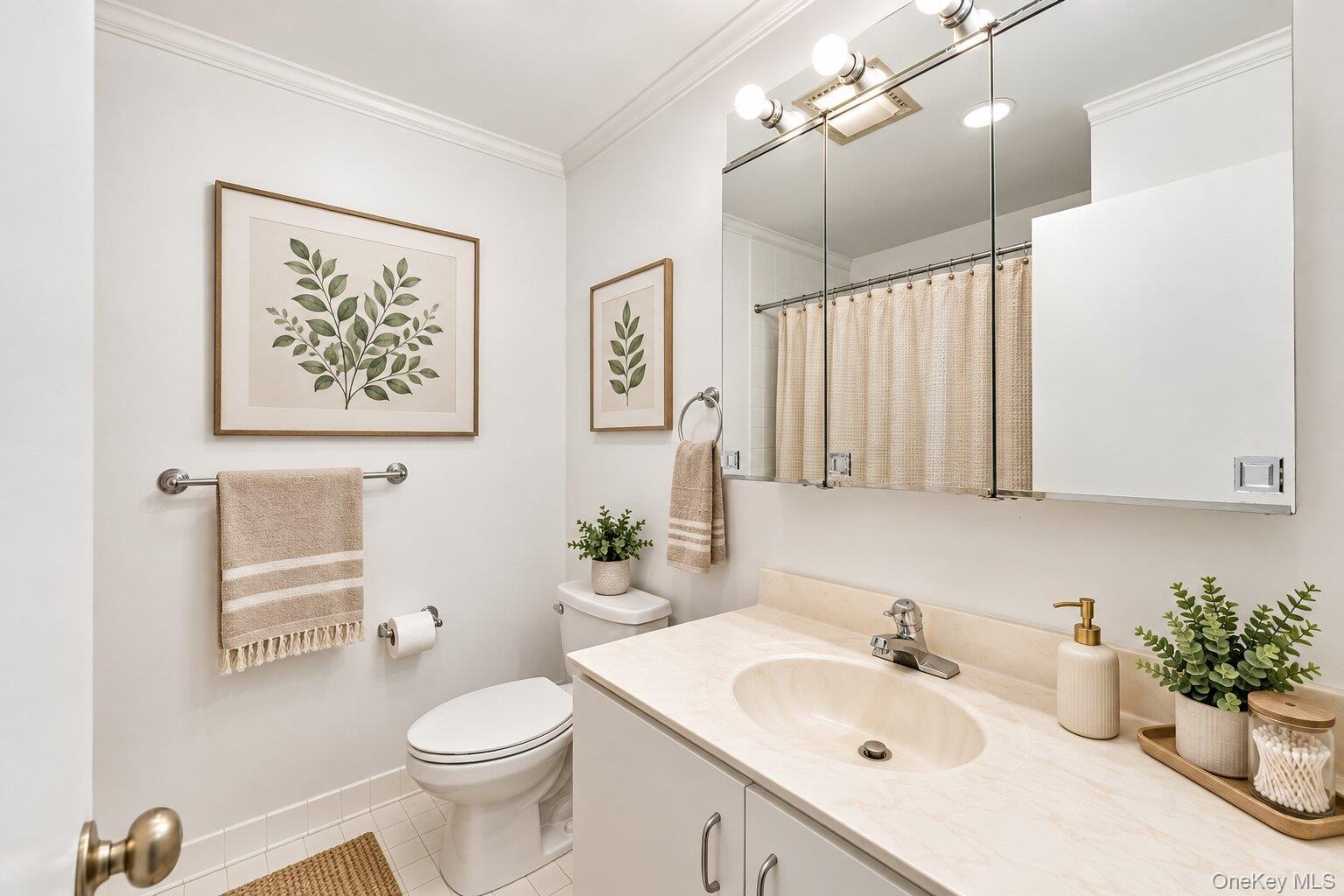 White vanity with an integrated oval sink, chrome faucet, and mirrored medicine cabinet