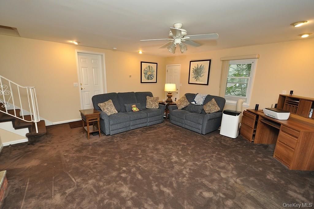 Lower Level recreation room has a fireplace, access to the outside, garage and utility room and storage.  The room is approx. 19'-4" x 18'-6".