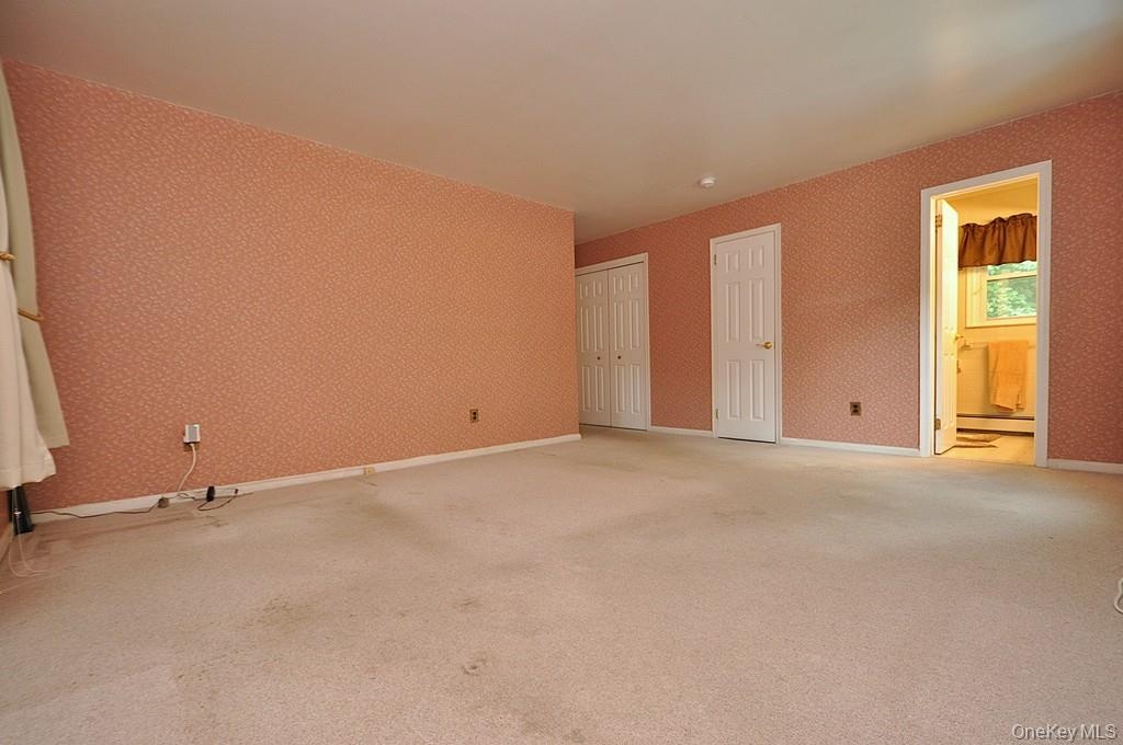 Large Primary Bedroom has wall to wall carpeting, two large closet and a private bath.  The room is approx. 16'-6" x 16'-2".