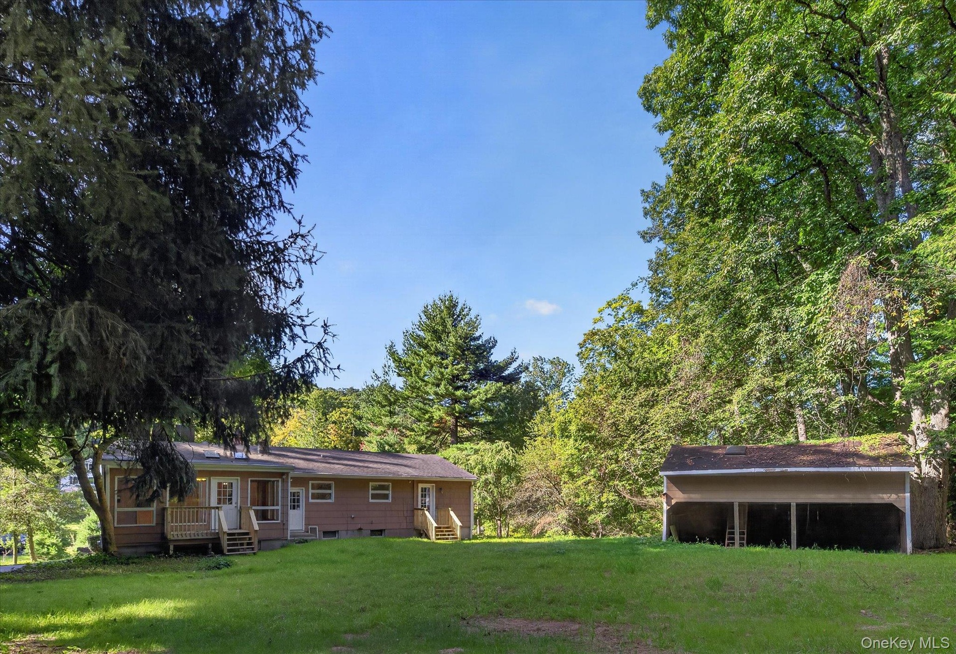 Flat Backyard with Ride-In Barn Behind Main Home