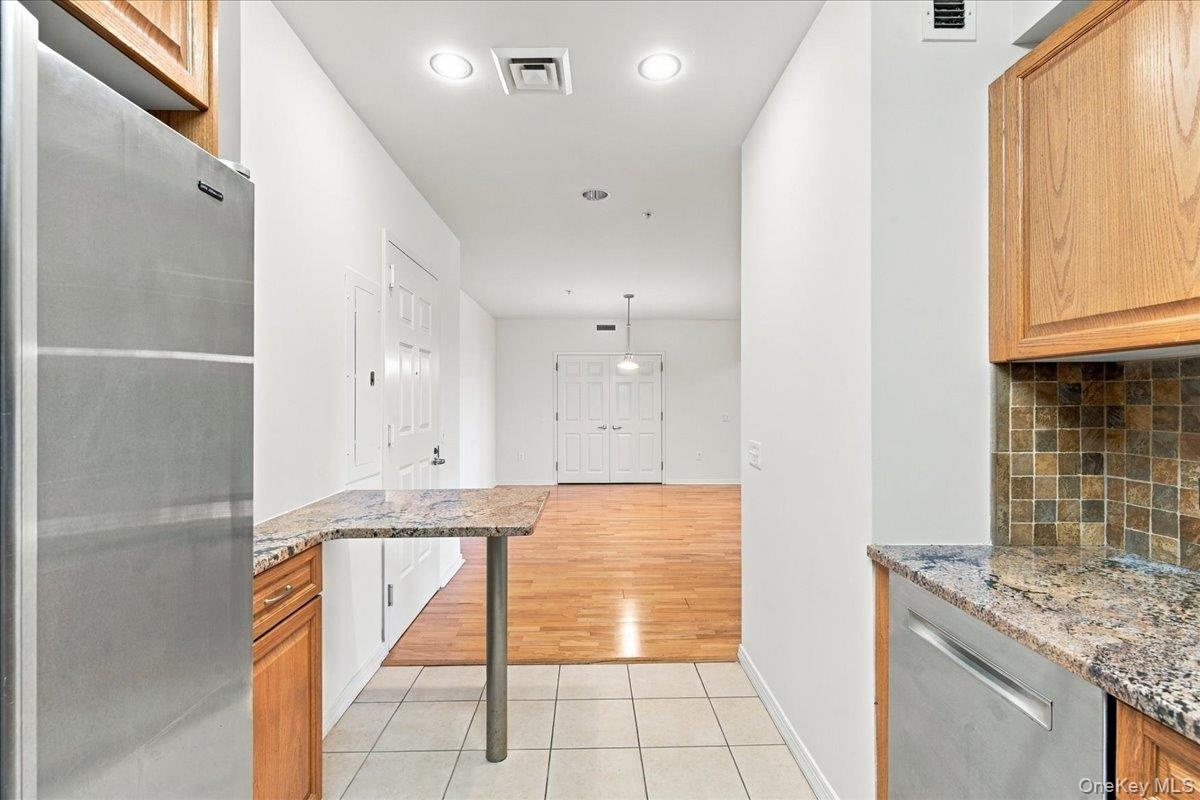 Stainless steel refrigerator and dishwasher with granite countertops