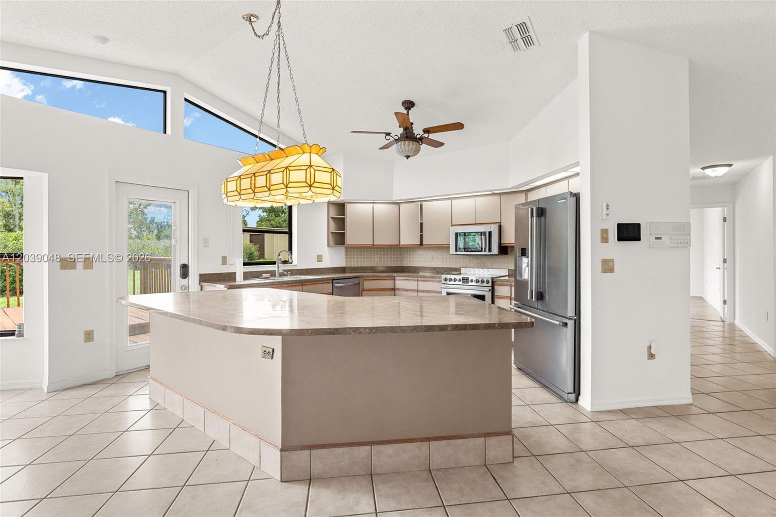 Functional kitchen with ample cabinetry and workspace, providing a practical layout with potential for modern updates or redesign to maximize value.