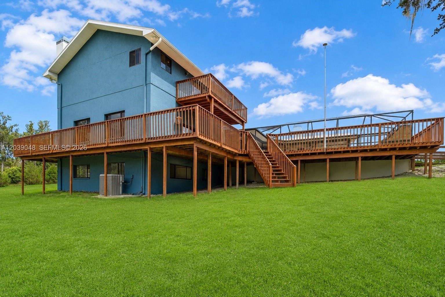 Rear view of the residence showcasing its private setting surrounded by natural Florida landscape and open space.