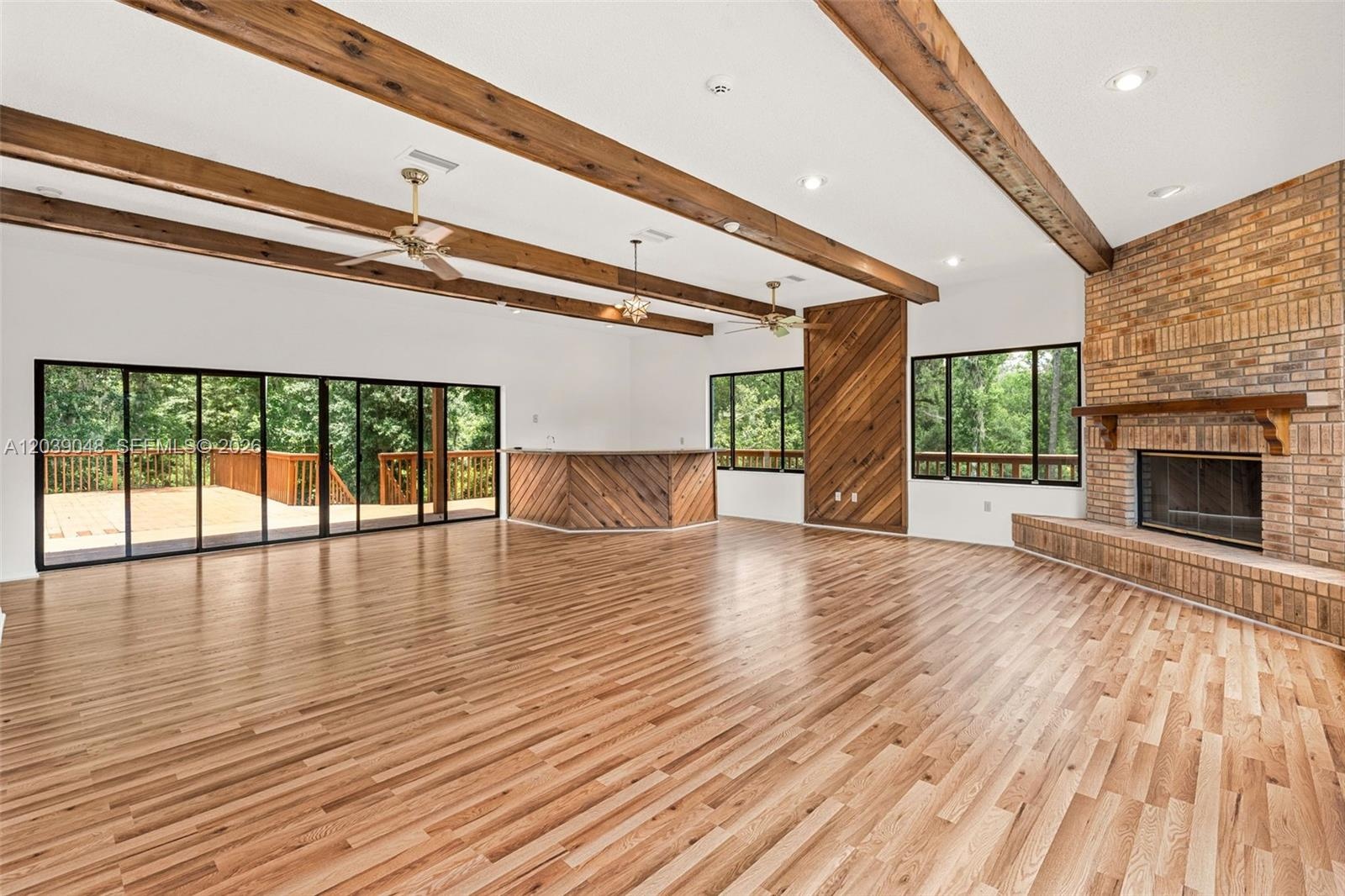 Spacious living area filled with natural light, offering a comfortable layout ideal for everyday living or future customization. A welcoming central g