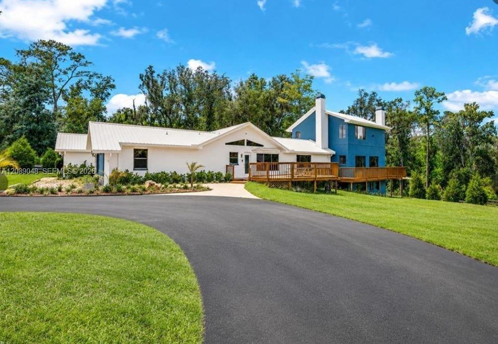 Welcome to a spacious rural property offering privacy, open land, and multiple structures including a residence and detached garage buildings.