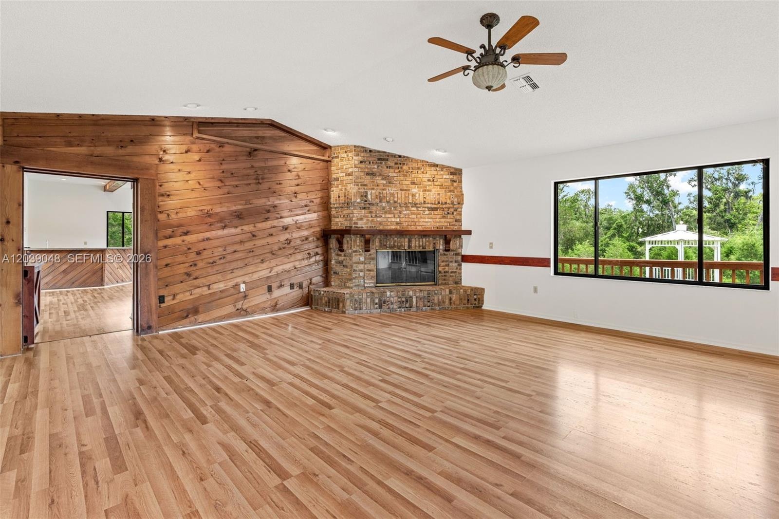 Cozy yet functional living room showcasing a fireplace feature wall with wood detailing, enhancing the home’s overall ambiance.