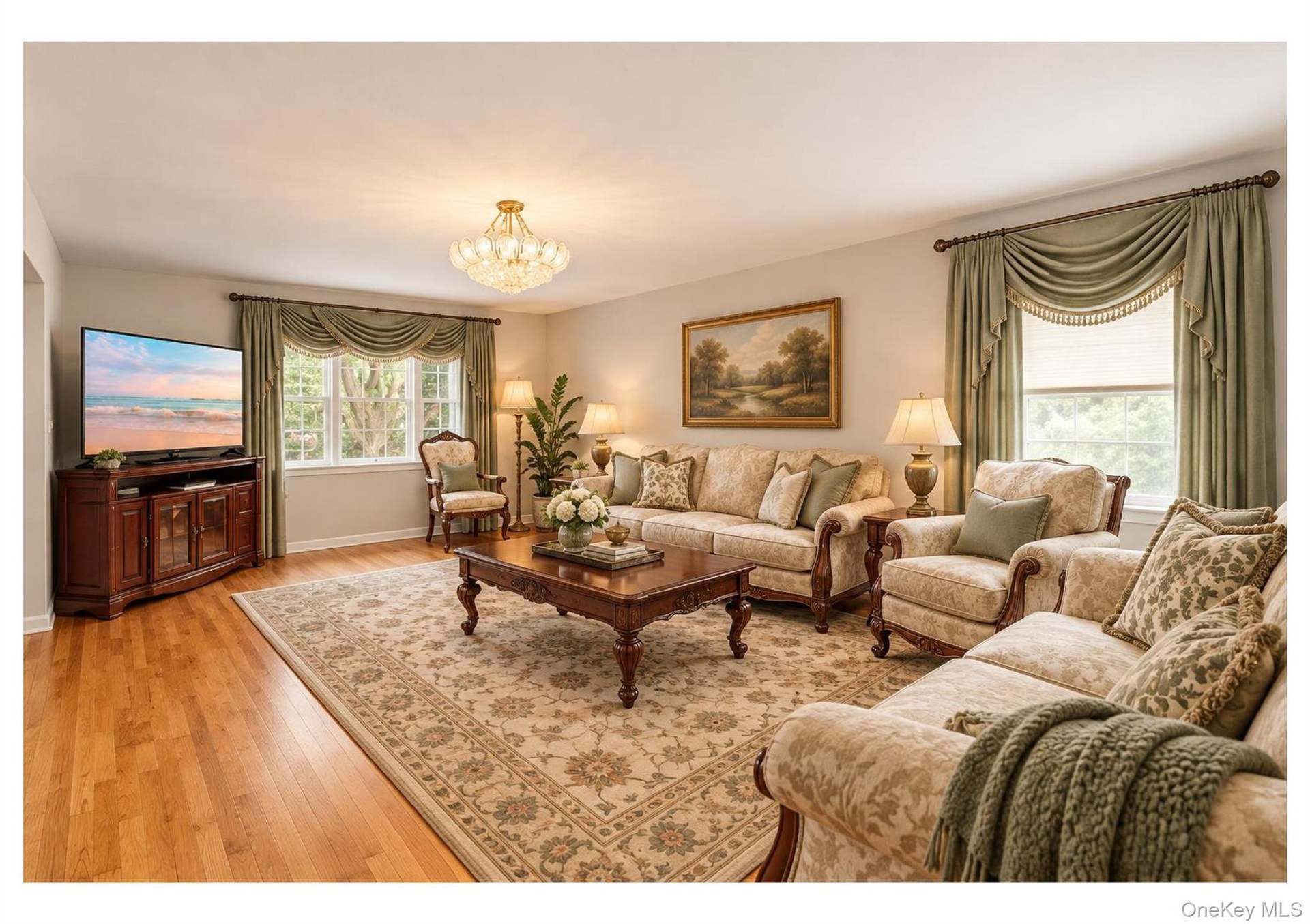 Hardwood flooring, natural light through multiple windows, decorative chandelier, light neutral wall colors, and classic window treatments